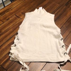 Sleeveless Turtleneck Sweater with lace up details on the side